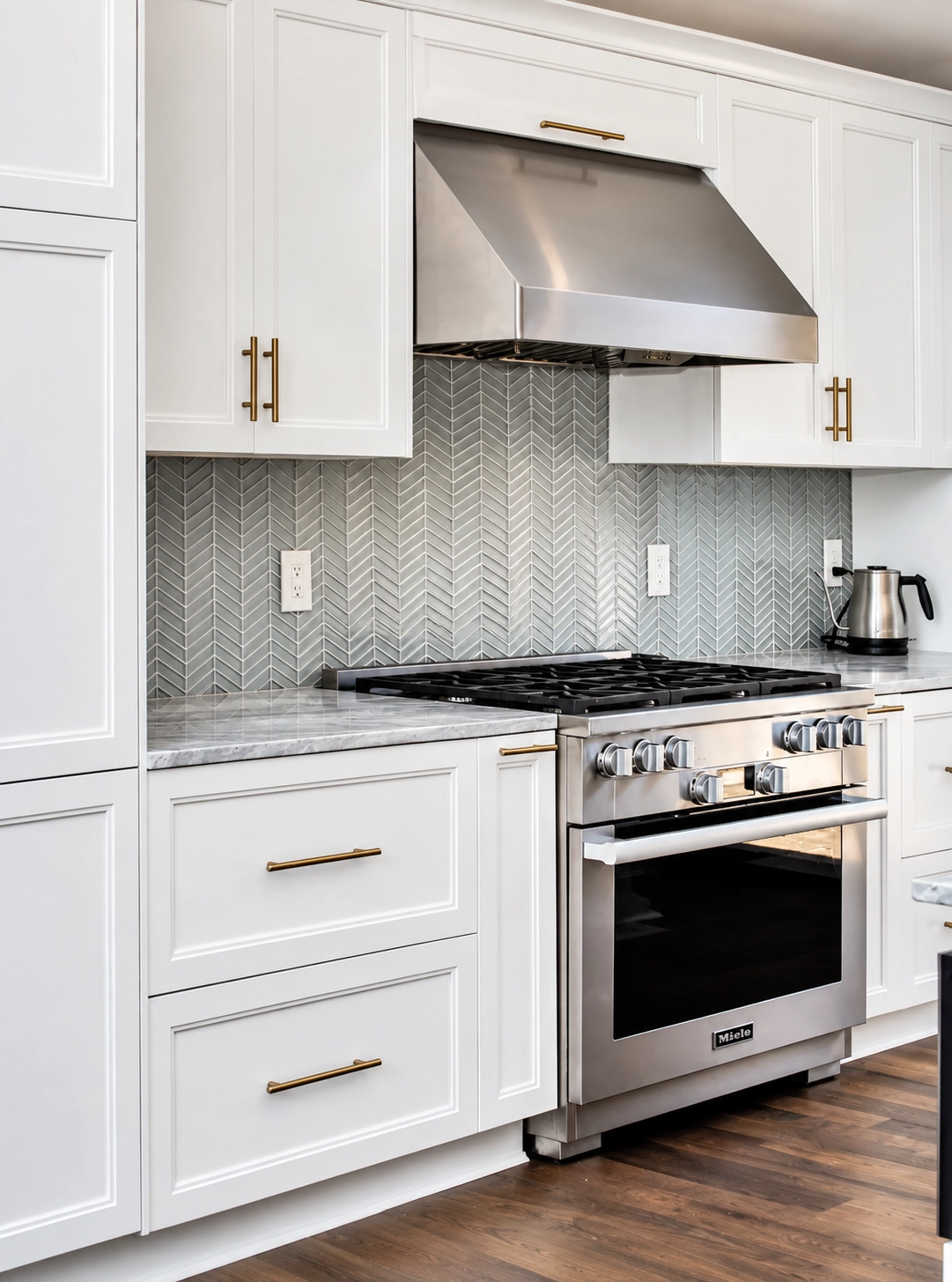 White shaker kitchen with stainless range hood