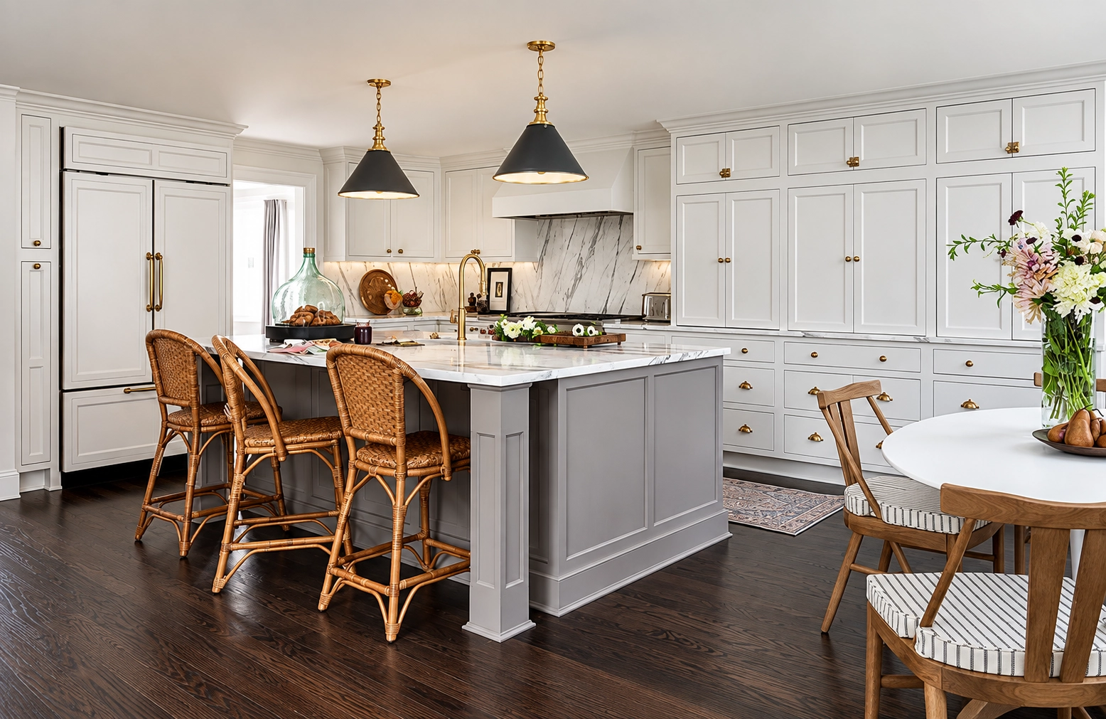 White inset kitchen with taupe island and rattan stools