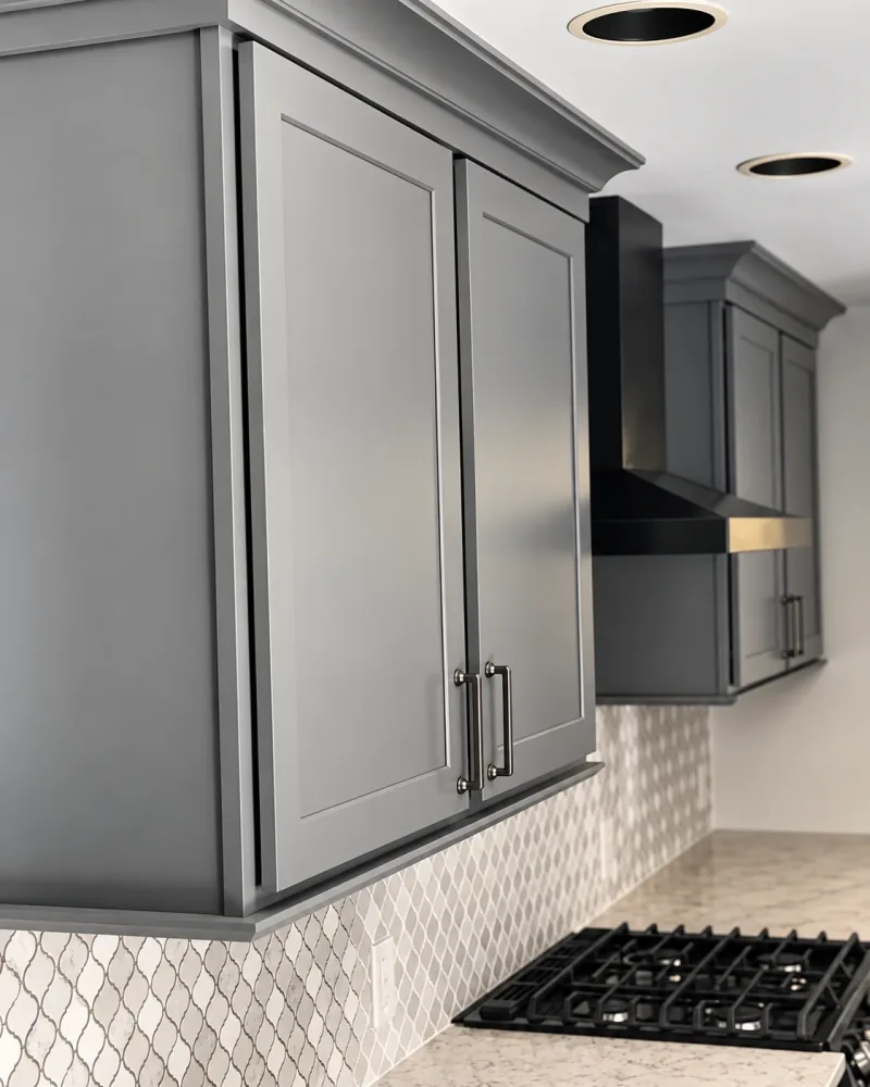 Gray cabinets over arabesque tile