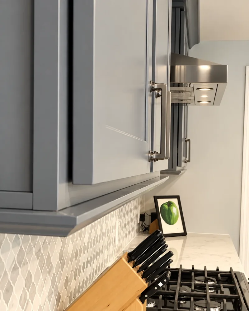 Gray wall cabinet beside the hood