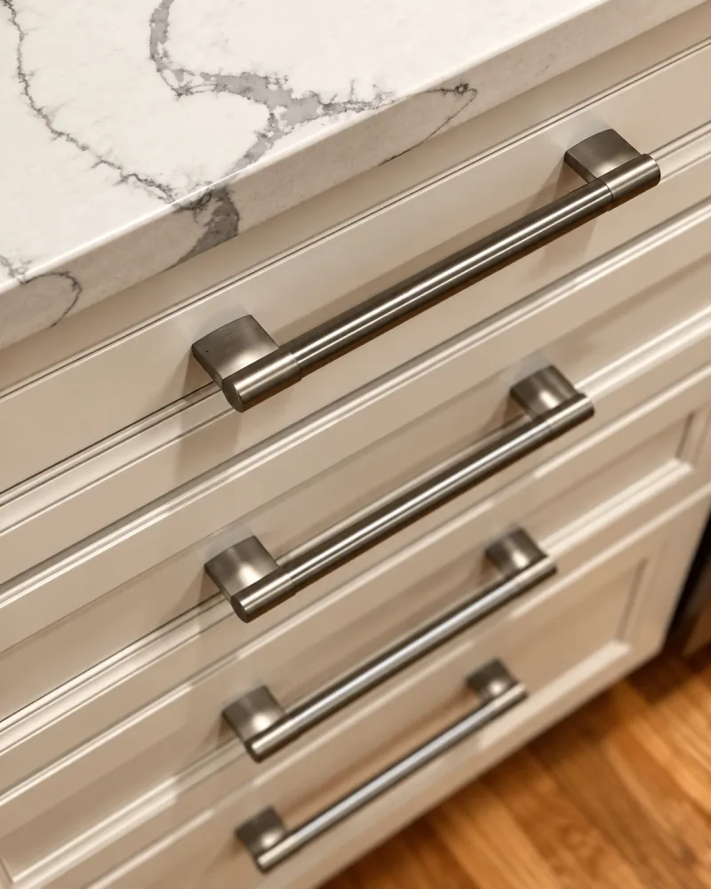 Satin bar pulls on white drawers