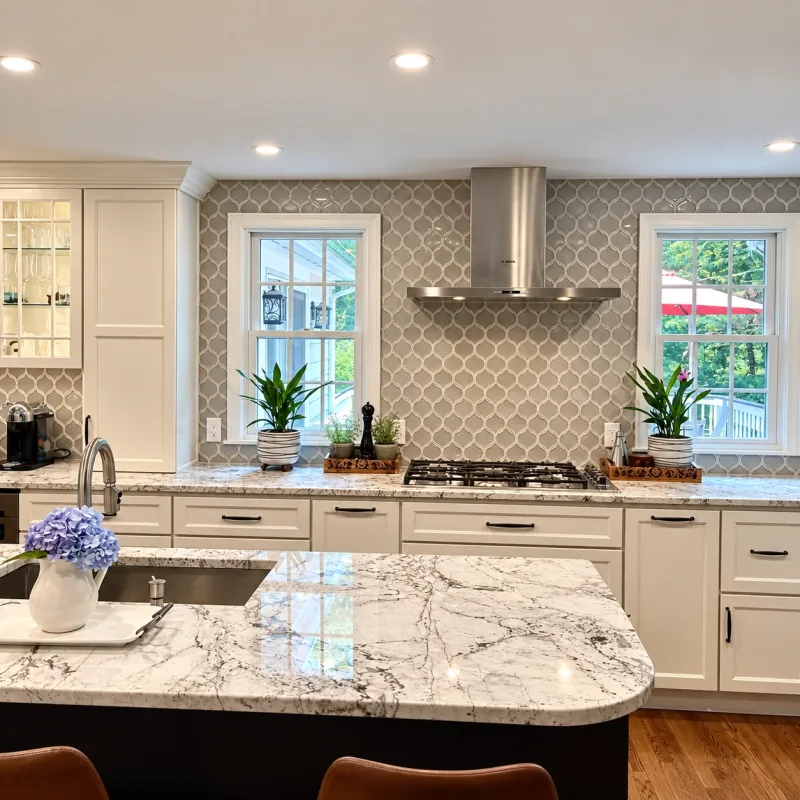 Rounded granite island and arabesque tile
