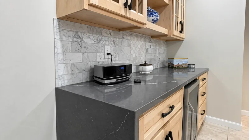 Maple cabinets with dark quartz waterfall
