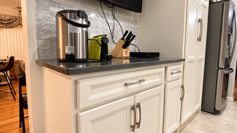 Raised-panel cabinets with dark quartz
