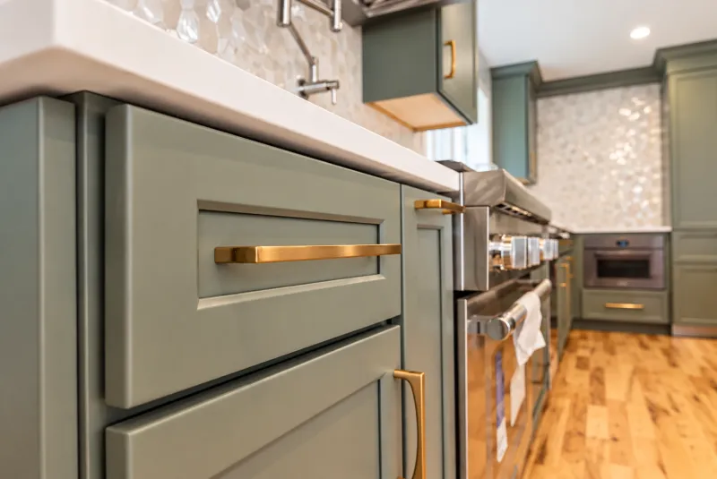 Sage green cabinets with brass pulls