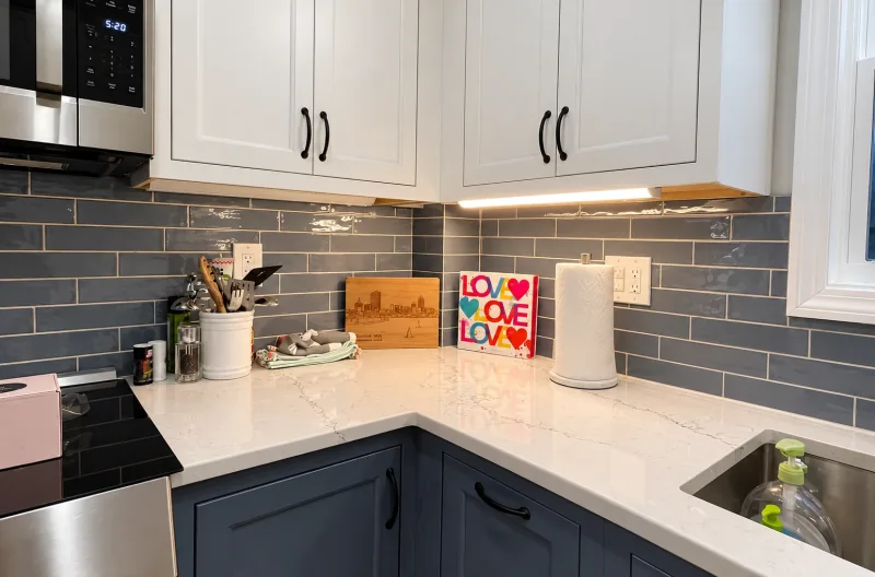 White uppers over blue subway tile